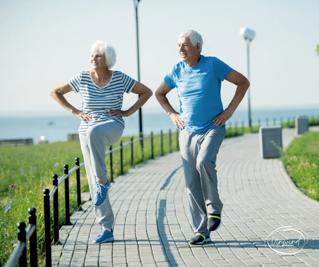 Elderly couple stretching on a path