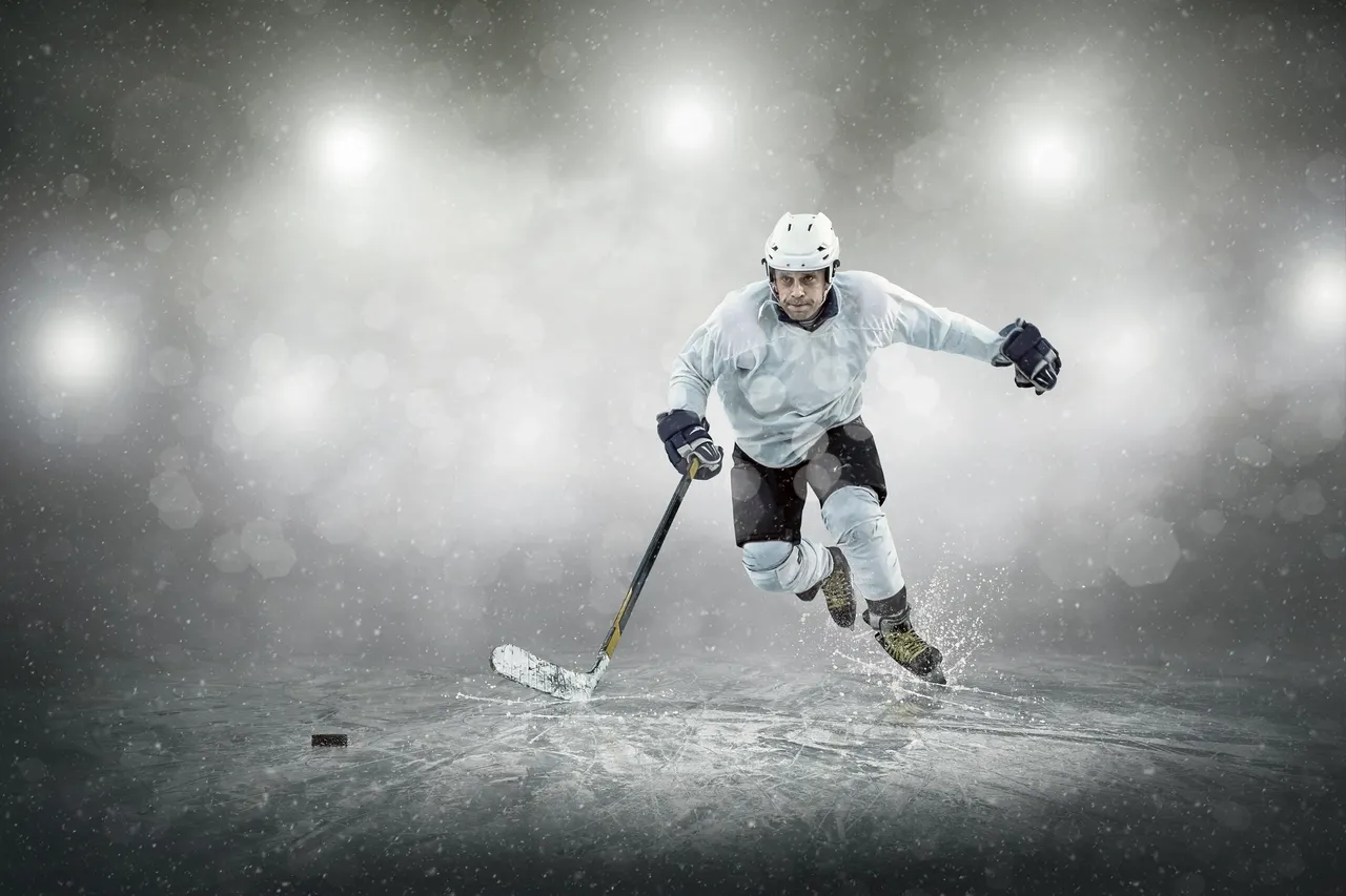 hockey player racing down the ice to reach the puck