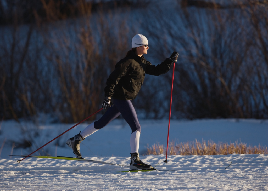 Athlete cross-country skiing smoothly through snow, demonstrating coordinated and efficient movement
